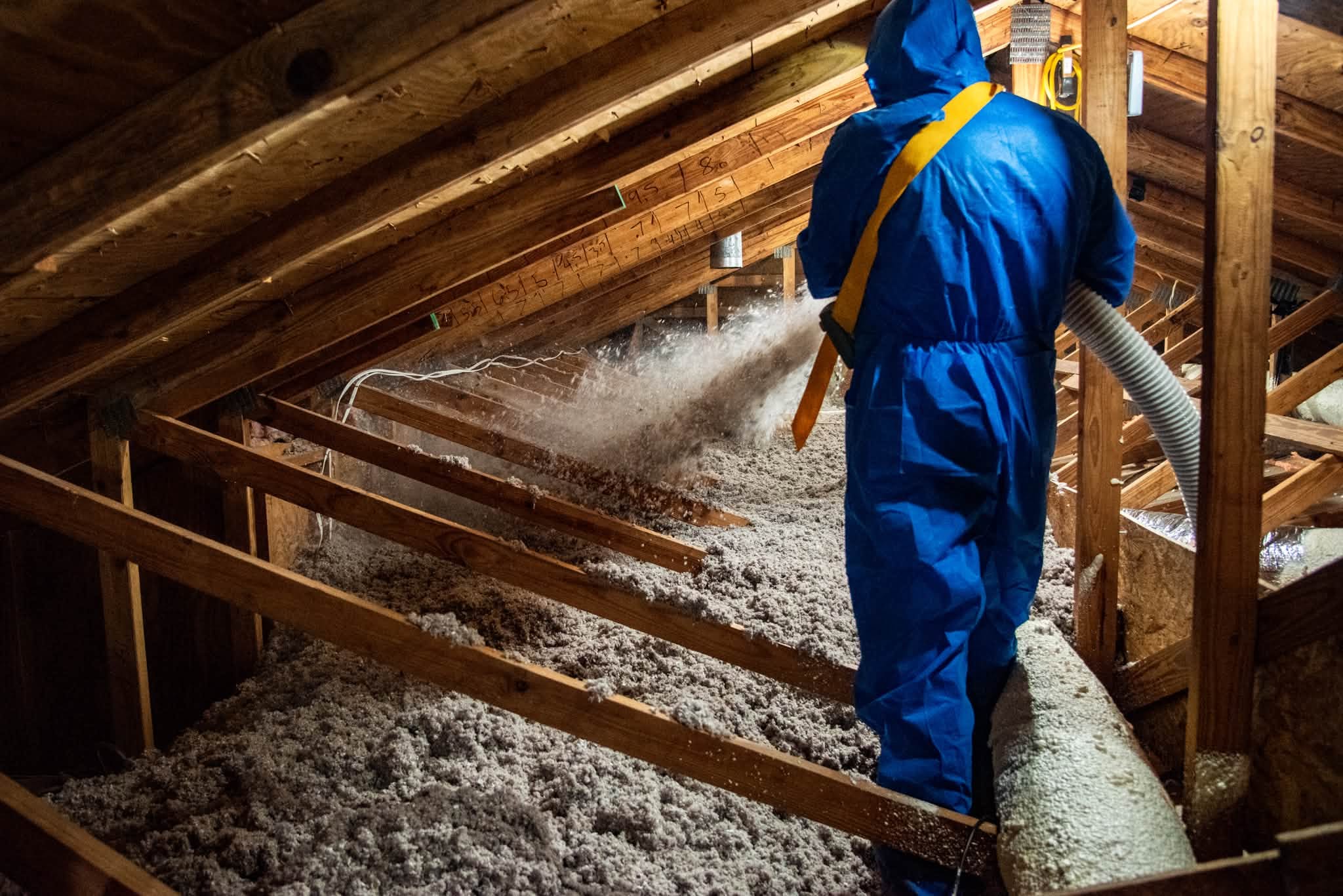 Restorative Home Solutions crew blowing cellulose insulation into a Fargo attic